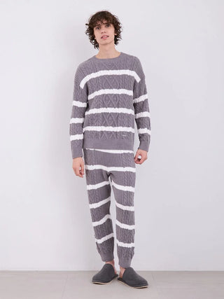 Model wearing Gelato Pique Men's Baby Moco Aran Border Pullover Sweater with cable knit design and horizontal stripes, in grey and white.