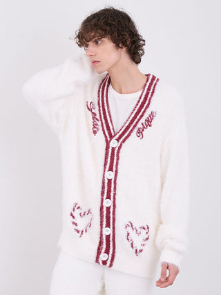 Model wearing mens feather button up cardigan with festive red accents on a white fluffy texture.