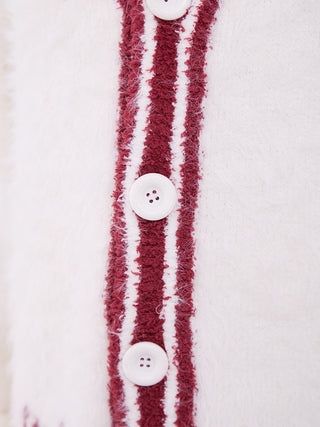 Close-up of buttons on a men's feather button-up cardigan with red and white stripe design, showcasing festive and cozy fabric texture.