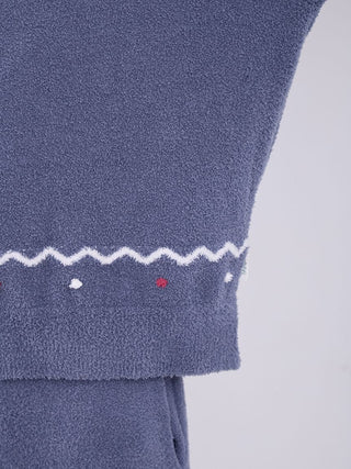 Close-up of Men's Nordic Pullover Sweater in blue showing zigzag and dot pattern, featuring soft fluffy fabric texture.