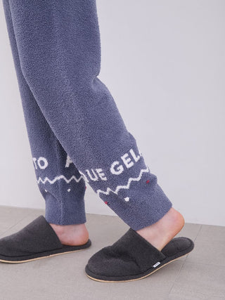 Close-up of Men's Nordic Lounge Set pajama pants in fluffy fabric with Nordic design, paired with cozy slippers.