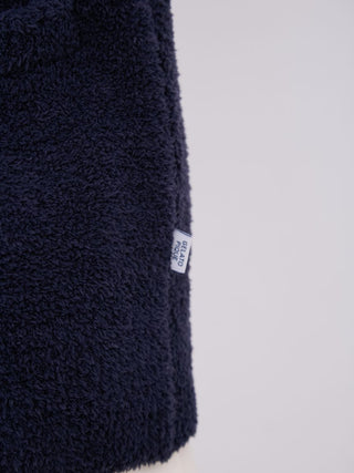 Close-up of navy knit fabric from MEN'S Powder Dinosaur Jacquard Knit Cardigan by Gelato Pique.