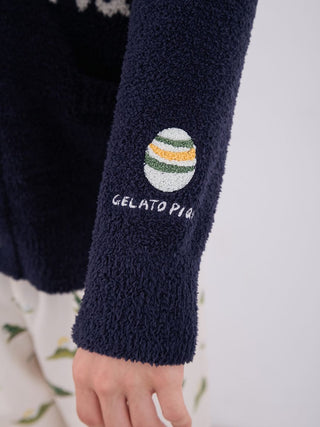 Close-up of sleeve detail on Gelato Pique Men's Powder Dinosaur Knit Cardigan, showcasing textured fabric and brand logo.