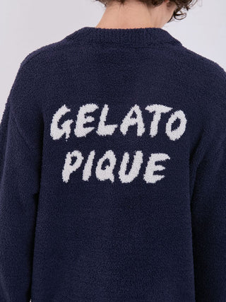 Back view of navy blue Gelato Pique cardigan with textured logo design, showcasing cozy knit material.