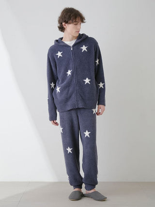 Model wearing a Powder Star Jacquard Zip Up Hoodie, navy blue with white star pattern, cozy winter loungewear.
