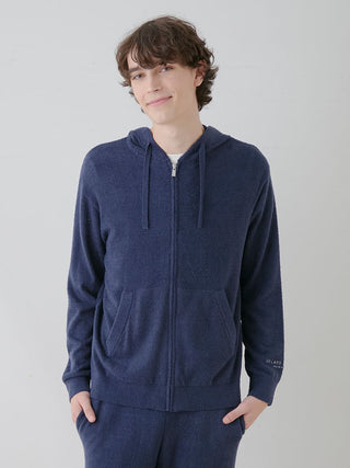 Man wearing Gelato Pique USA Temperature-Control Smoothie Zip-Up Hoodie in navy blue, showcasing comfort and style for casual outings.