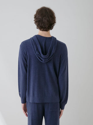 Back view of a person wearing a dark blue Gelato Pique USA Temperature-Control Smoothie Zip-Up Hoodie, featuring a cozy and breathable design.