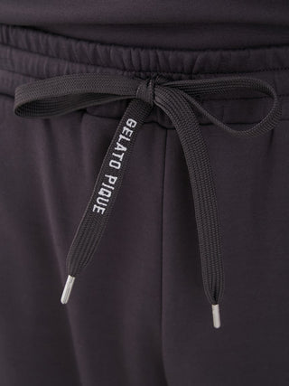 Close-up of black unisex lounge shorts with Gelato Pique logo on drawstring, showcasing quality fabric and stylish design.