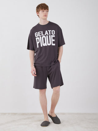 Model wearing Gelato Pique unisex big logo lounge shorts and matching top, showcasing relaxed fit and trendy design in a stylish setting.