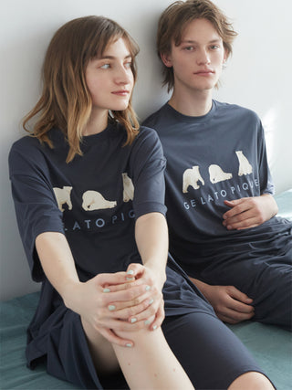 Two people wearing Cool Summer Polar Bear unisex lounge shorts and shirts by Gelato Pique, sitting on a sofa.