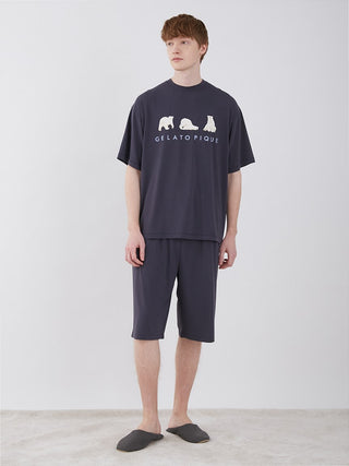 Model wearing Gelato Pique Cool Polar Bear unisex lounge shorts set in dark color, showcasing comfort and style for summer relaxation.
