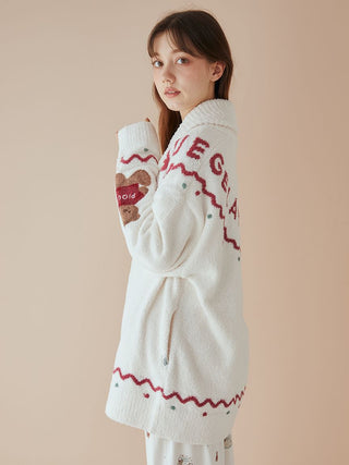 Model wearing unisex Nordic shawl collar cardigan with teddy bear design and zigzag trim, showcasing festive style and warmth.