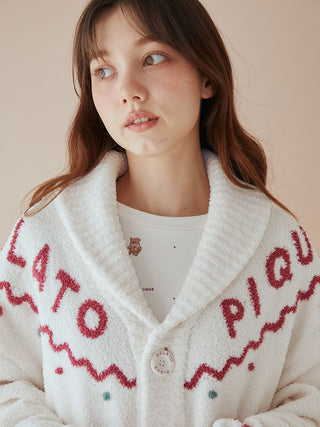 Model wearing unisex Nordic shawl collar cardigan with Gelato Pique's plush fabric, featuring zigzag trims and teddy bear detailing.