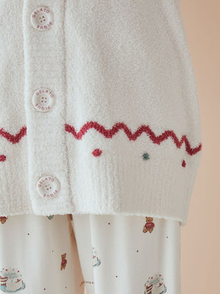 Close-up of unisex Nordic shawl collar cardigan with zigzag trims and teddy bear motif, crafted from Gelato Pique's plush fabric.