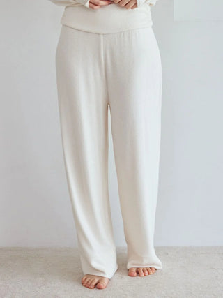 Model wearing Snow High-Waisted Lounge Pants with wide-leg design, showcasing luxurious and soft fabric for ultimate comfort. Gelato Pique.