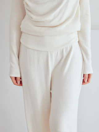 Model wearing cream Snow high-waisted lounge pants with wide leg silhouette from Gelato Pique USA, showcasing effortless chic loungewear.
