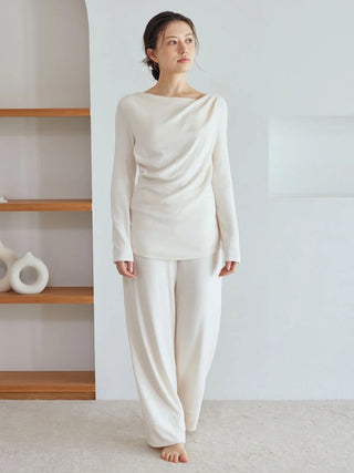 Model wearing Snow High-Waisted Lounge Pants in white for a cozy, chic look, emphasizing soft fabric and relaxed fit by Gelato Pique USA.