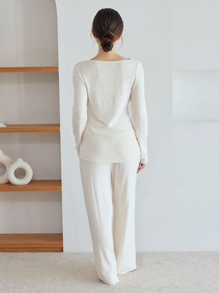 Back view of model wearing Snow High-Waisted Lounge Pants in cream, featuring wide-leg silhouette for comfort and style in loungewear.
