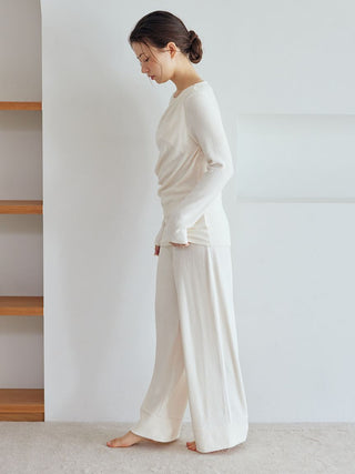 Woman wearing Snow High-Waisted Lounge Pants showcasing wide-leg silhouette and soft fabric for comfort.