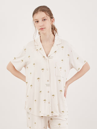 Model wearing a Fruit Motif Loungewear Sleep Shirt in soft rayon, showcasing a summertime chic design with small palm tree prints.