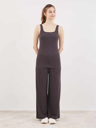 Woman wearing Water Absorption Tank Top in black by Gelato Pique USA, highlighting style and comfort with premium teleco fabric.