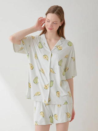 Woman wearing Fruit Pattern Pajama Sleep Shirt with pear design, short sleeves, and button front, from GELATO PIQUE USA.