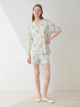 Woman wearing a Fruit Pattern Pajama Sleep Shirt with a pear motif, designed by GELATO PIQUE USA. Ideal for restful and stylish sleep.