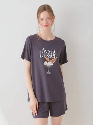 Woman wearing COOL Rayon Dessert Logo Relaxed Fit T-shirt with 'Avant Dessert' graphic, showcasing casual comfort and chic style.