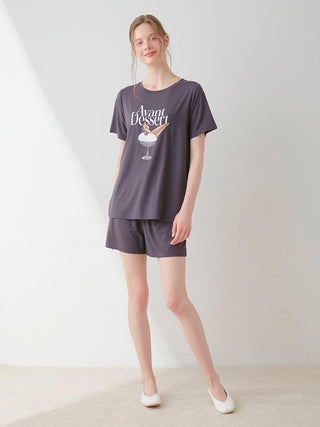 Model wearing COOL Rayon Dessert Logo Relaxed Fit T-shirt in dark shade, featuring "Avant Dessert" print, showcasing casual style.