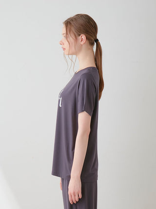 Side view of model wearing COOL Rayon Logo Relaxed Fit T-shirt in gray, emphasizing its soft rayon fabric and casual style.