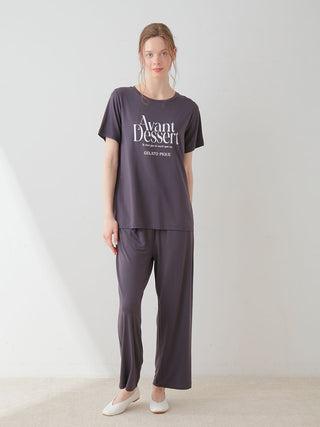 Woman wearing Avant Dessert Rayon Logo Relaxed Fit T-shirt in dark color, showcasing comfort and style in casual lounge attire.