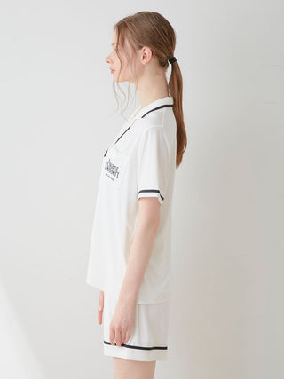 Woman wearing COOL Rayon Logo Button-Up Sleep Shirt in white, side view showcasing chic design and comfort.