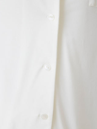 Close-up of white rayon button-up sleep shirt showcasing details and fabric texture.