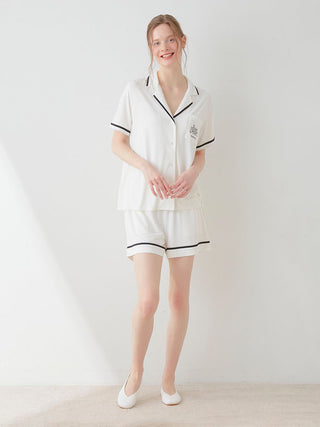 Woman wearing COOL Rayon Logo Button-Up Sleep Shirt by Gelato Pique USA, showcasing chic comfort and casual elegance in white.