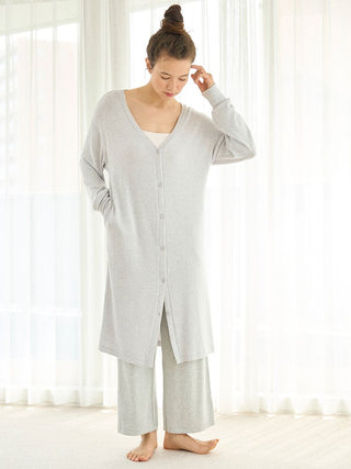 Woman wearing a cozy Snow Long Cardigan with deep V-neckline, ideal for lounging. Elegant, relaxed fit in soft fabric. Perfect for home style.