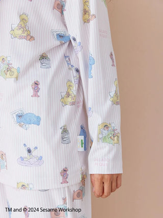 Close-up of Sesame Street all-over print pullover in soft rayon-blend fabric, featuring characters and Henley-neck design by Gelato Pique.