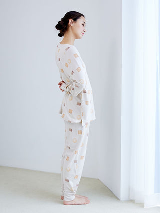 Side view of a model wearing a Biscuit Pattern Waffle Long Sleeve T-shirt with matching pants, featuring a cozy and playful design.