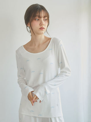 Woman wearing Motif 3-Pattern Long Sleeve T-Shirt with elegant bow motif print, showcasing soft, breathable lounge wear top by Gelato Pique USA.