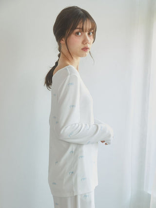 Woman wearing Motif 3-Pattern Long Sleeve T-Shirt with delicate bow motif and soft fabric from Gelato Pique USA, perfect for lounging.