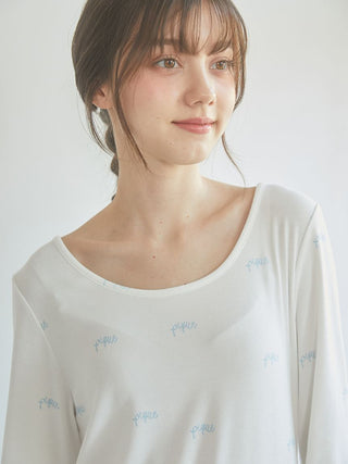 Elegant woman wearing a Motif 3-Pattern Long Sleeve T-Shirt by Gelato Pique, featuring soft fabric and delicate bow motif design.