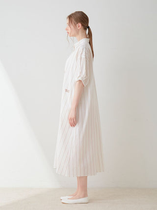 Side view of a woman wearing a Resort Woven Striped Shirt Midi Dress in neutral tones, featuring a sophisticated vertical stripe pattern.