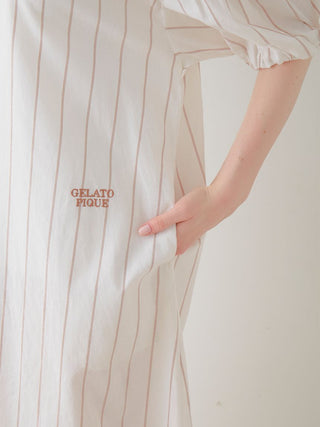 Close-up of Resort Woven Striped Shirt Midi Dress showing vertical stripes and embroidered Gelato Pique logo on white fabric.