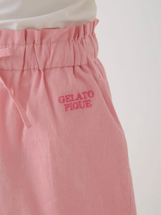 Close-up of soft pink resort woven lounge shorts with "Gelato Pique" embroidery, showcasing comfort and elegance.