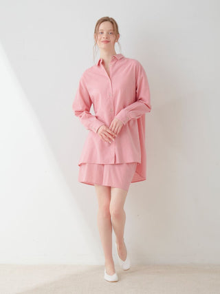 Woman wearing soft pink Resort Woven Lounge Shorts with matching oversized shirt, embodying ultimate comfort and casual elegance.