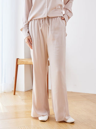 Luxurious satin pajama pants with elegant sheen and relaxed fit, showcasing silky-soft fabric for comfortable lounging or sleeping.