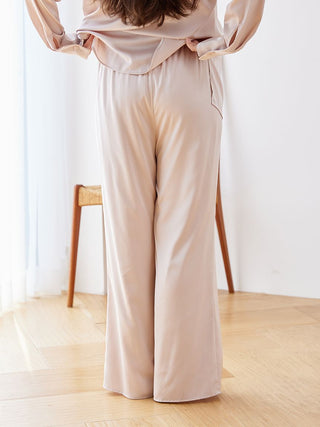 Luxurious satin pajama pants in elegant beige, showcasing a relaxed fit and silky sheen for comfortable lounging or sleeping.