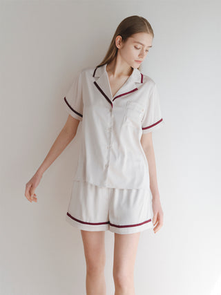Model wearing lined satin sleep shirt with collar, showcasing its luxurious sheen and chic design, part of the elegant satin series.
