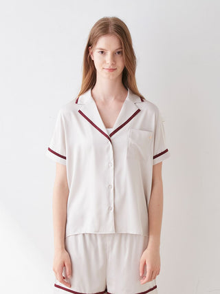 Lined satin sleep shirt with collar, featuring a luxurious sheen and elegant trim, worn by model. Perfect blend of comfort and style.