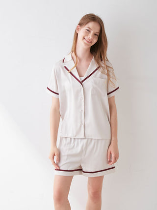 Woman wearing a lined satin sleep shirt with collar, featuring a chic design and luxurious fabric for elegant comfort.