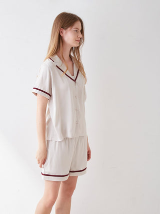 Woman wearing Lined Satin Sleep Shirt with collar, showcasing luxurious comfort and chic design in elegant satin fabric.